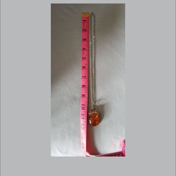 Attractive, faux amber pendant on a silver colored chain. - Picture 4 of 4